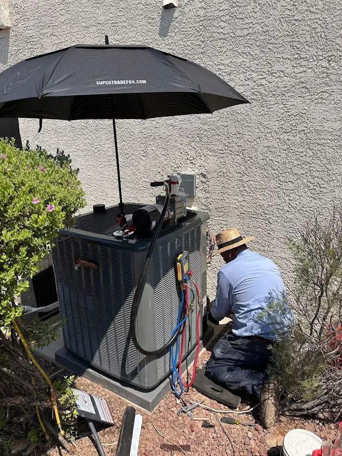 HVAC technician performing outdoor AC maintenance in Swarthmore
