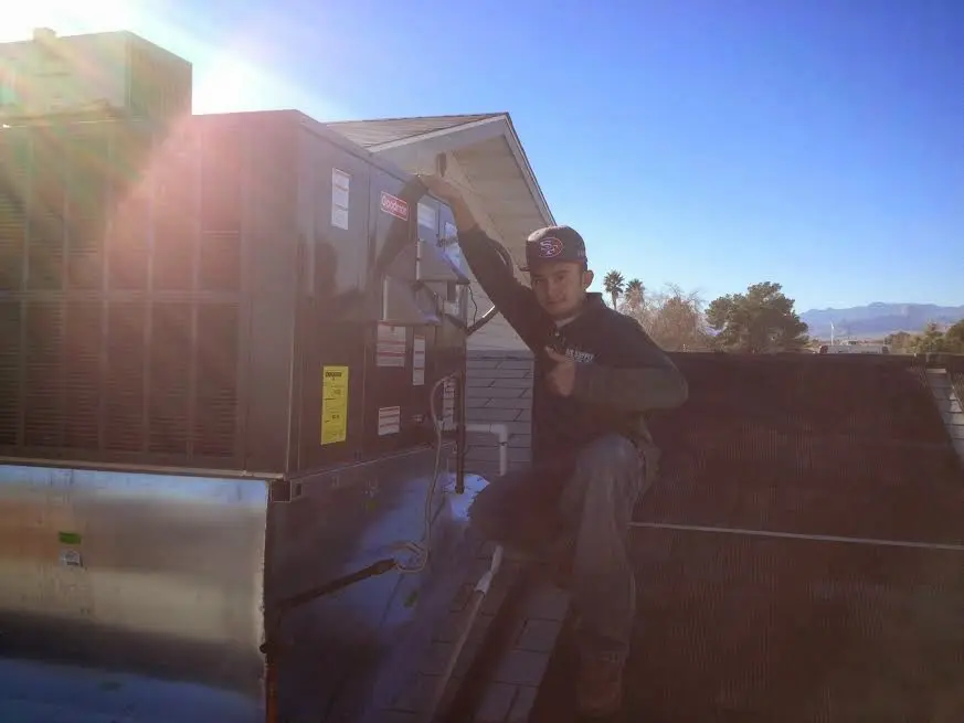 HVAC technician performing HVAC Inspection on a rooftop unit in Swarthmore